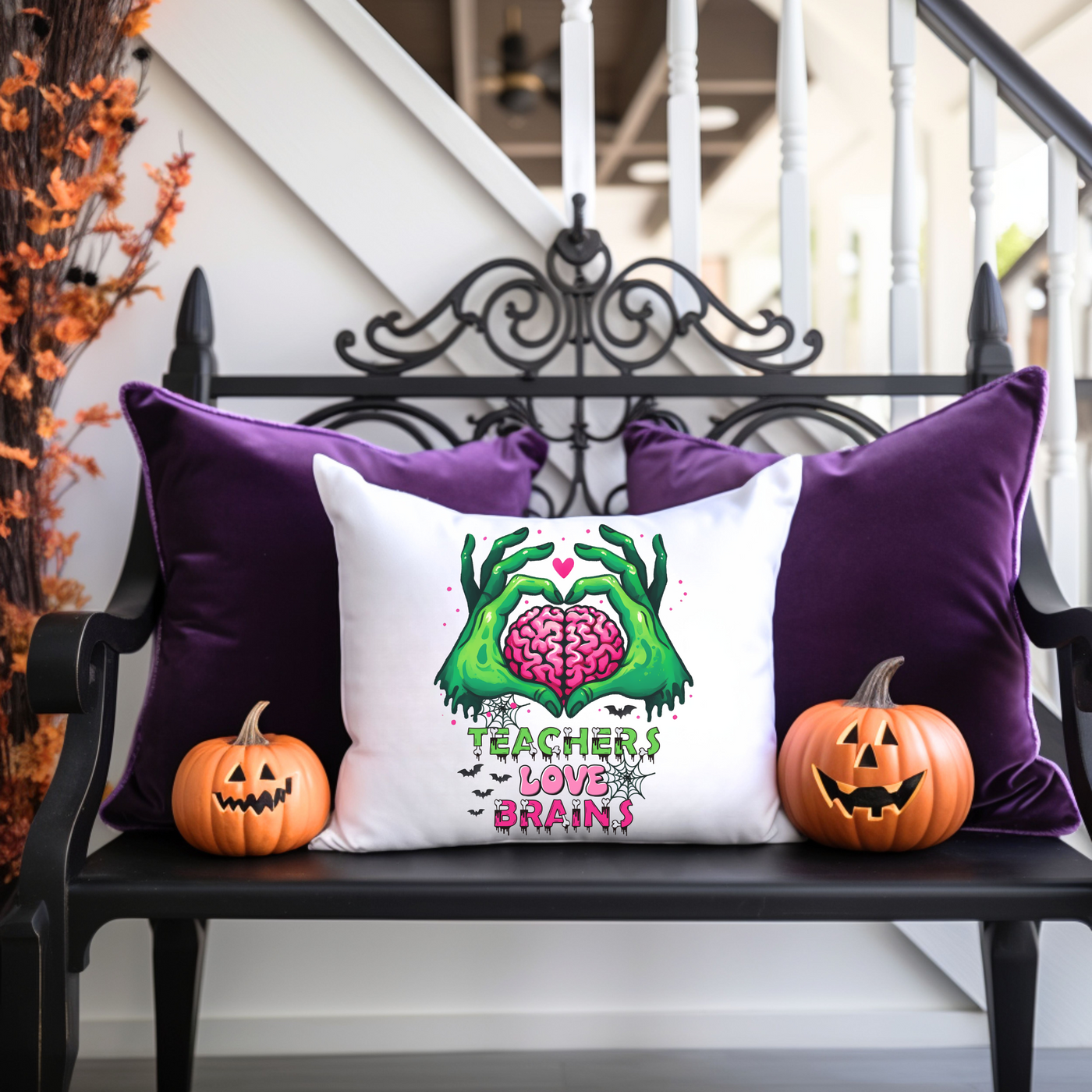 a bench with two pumpkins and a pillow on it