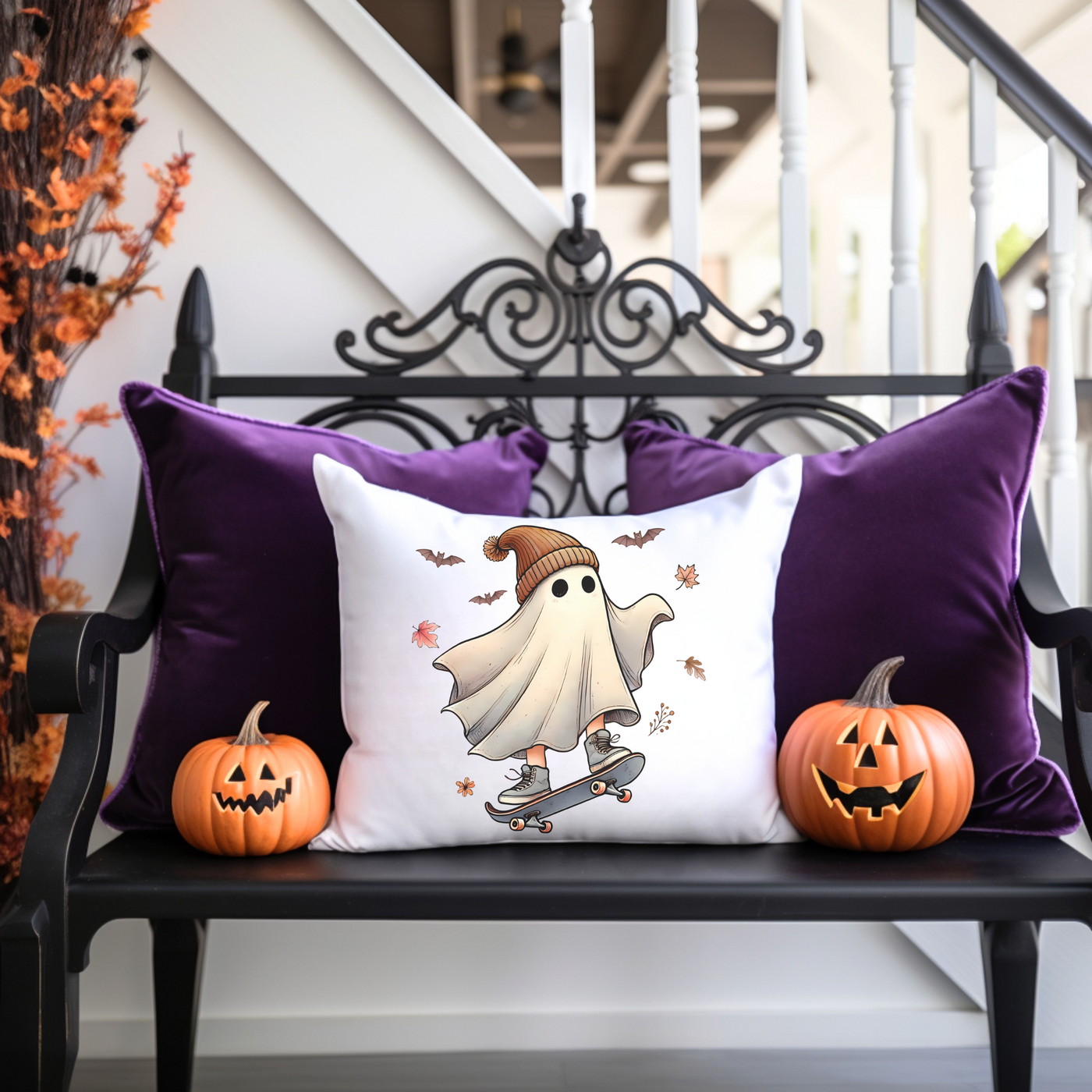 a bench with two pumpkins and a pillow on it