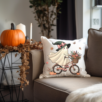 a decorative pillow with a witch riding a bike