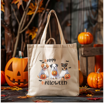 a bag with three dogs on it sitting in front of pumpkins