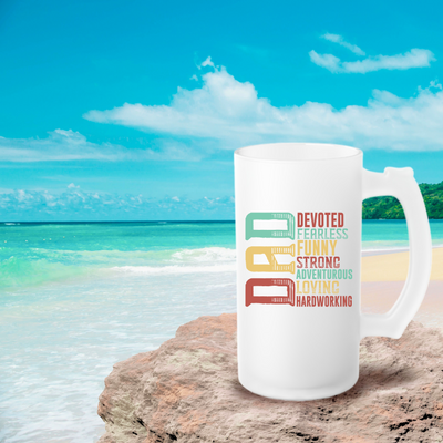 a white coffee mug sitting on top of a sandy beach