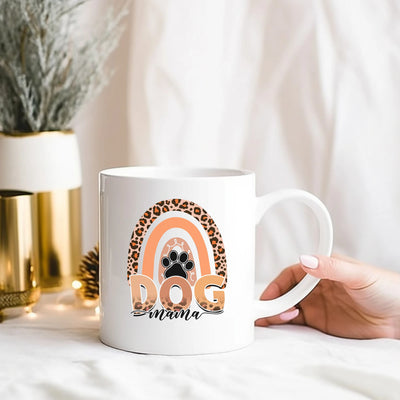 a person holding a coffee mug with a dog on it