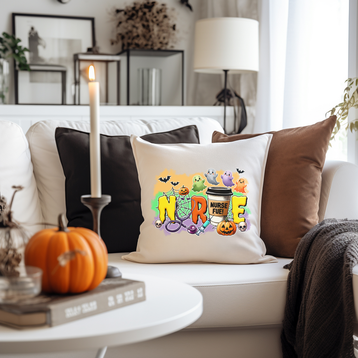 a white couch with halloween pillows and a candle