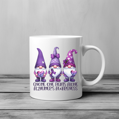 a white coffee mug with three gnomes on it