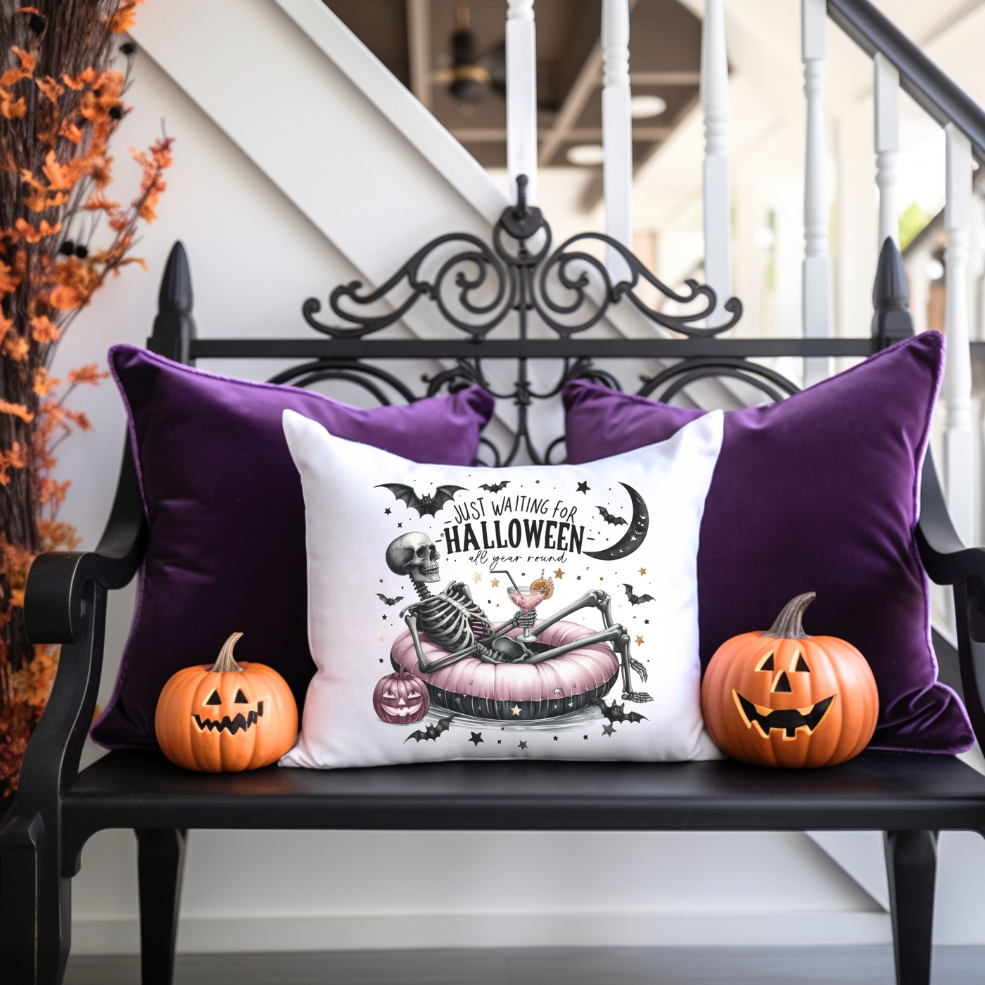 a bench with two pumpkins and a pillow on it