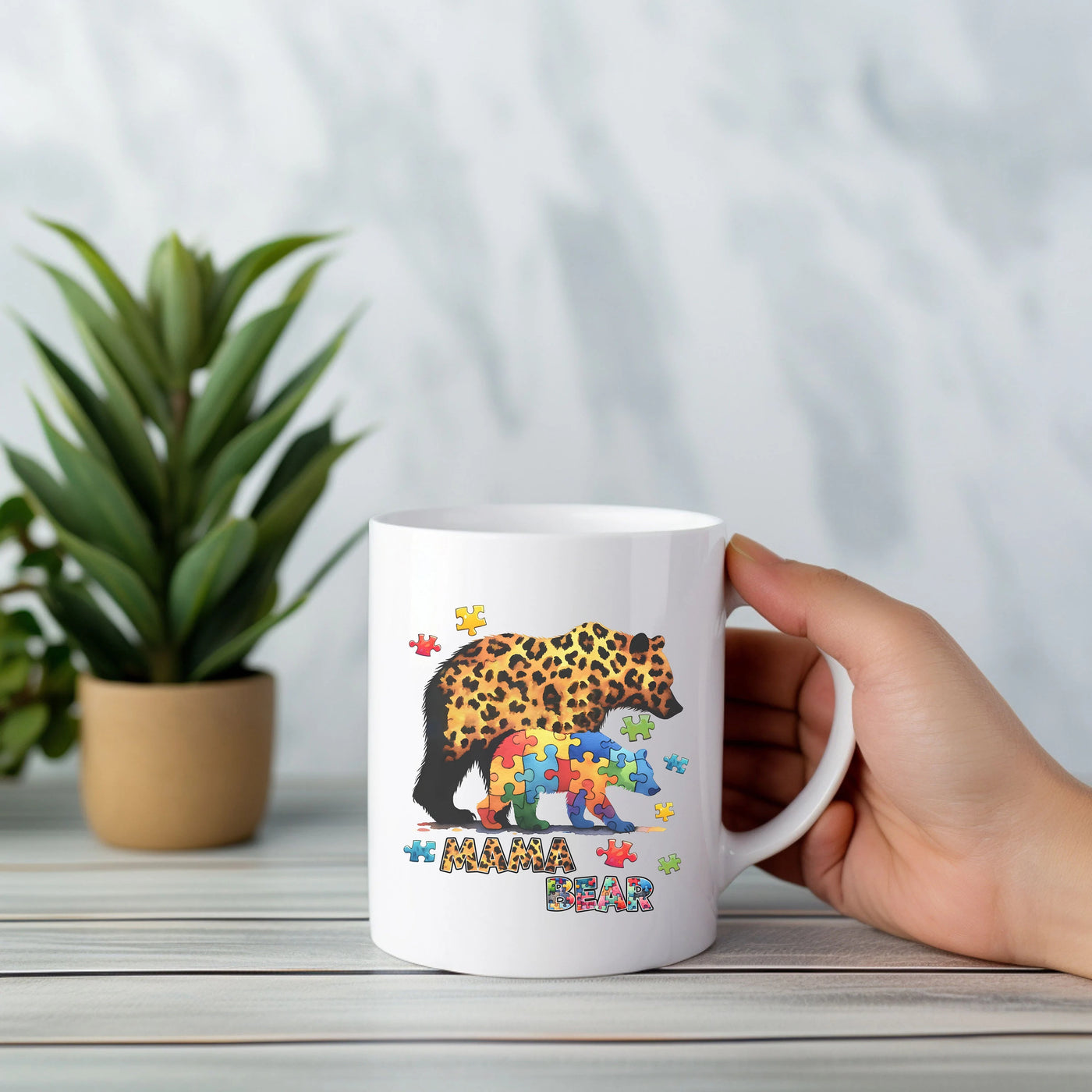 a person holding a coffee mug with a picture of a leopard on it