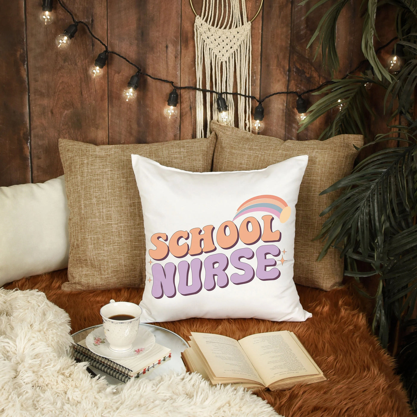 a pillow that says school nurse next to a cup of coffee