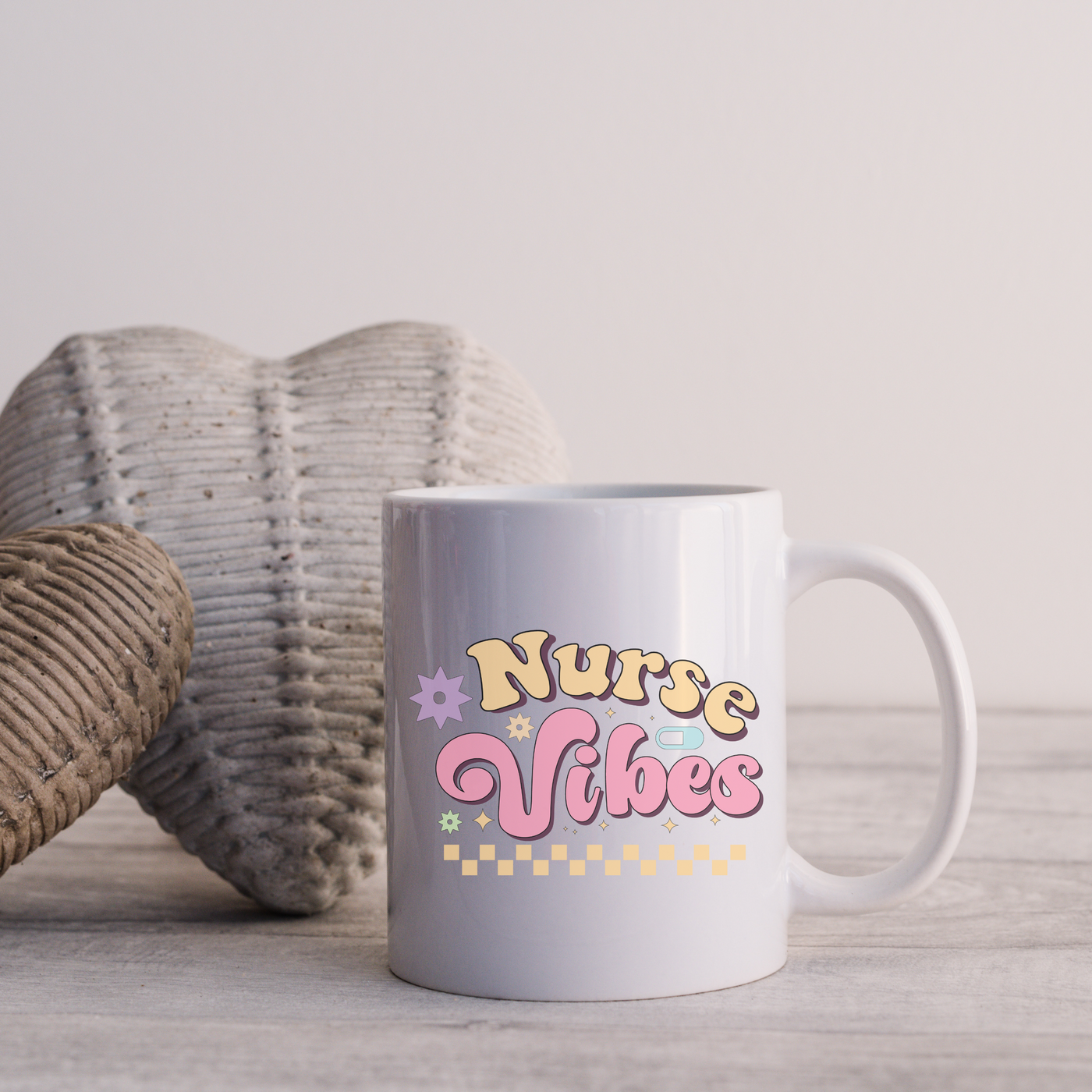 a white coffee mug sitting on top of a wooden table