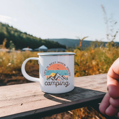 a person holding a coffee mug on a wooden table