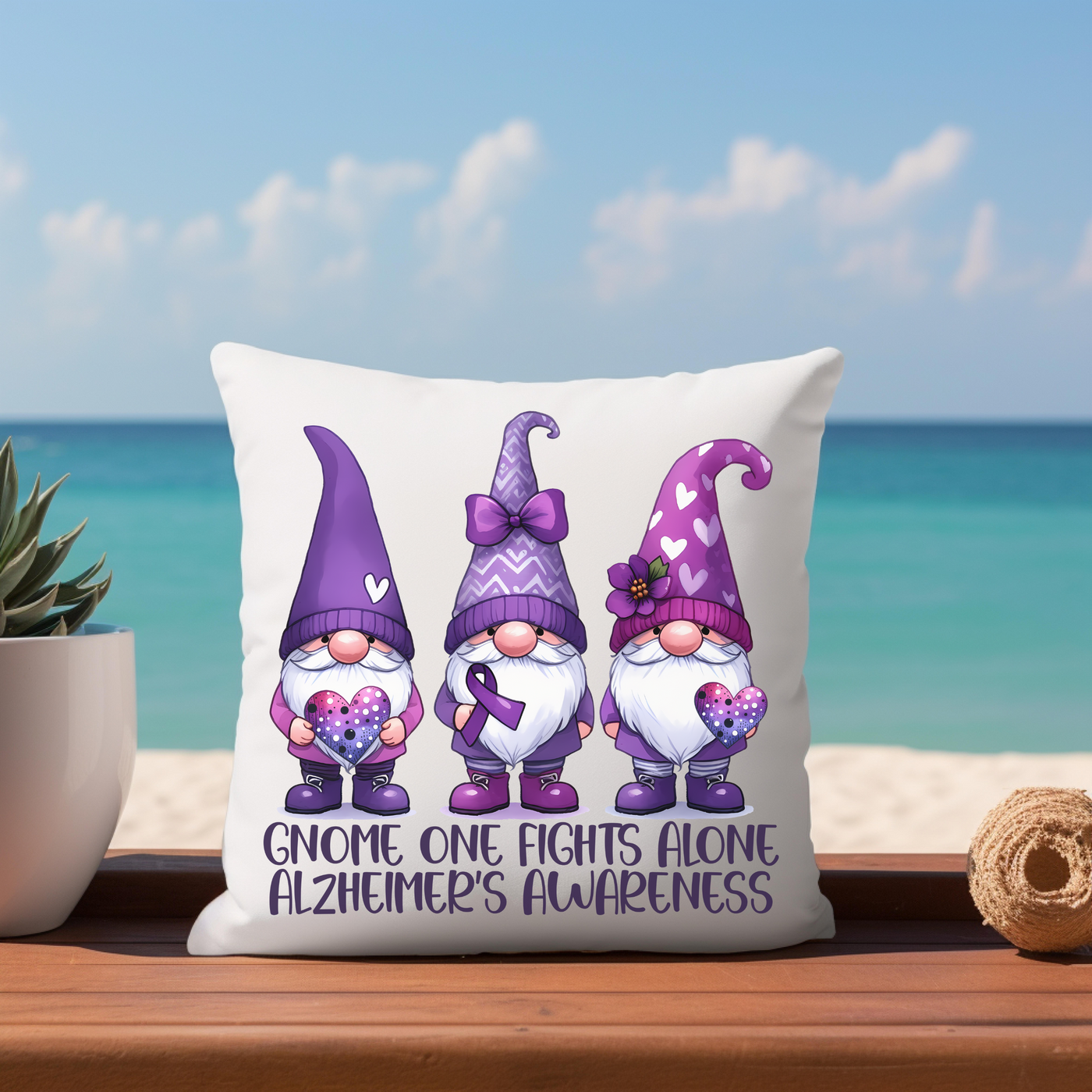 a pillow with three gnomes on it next to a potted plant