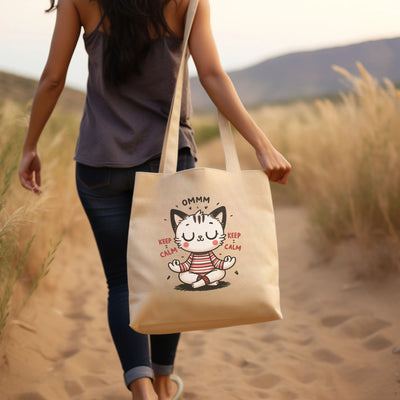 a woman walking down a dirt road carrying a tote bag