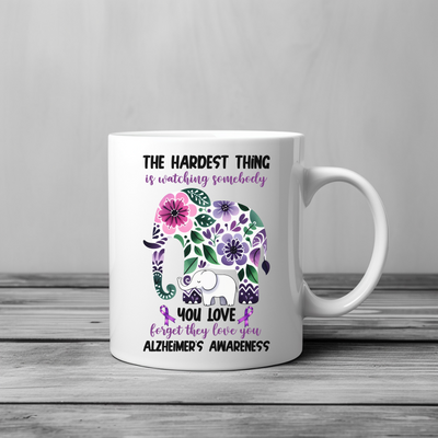 a coffee mug with an elephant and flowers on it