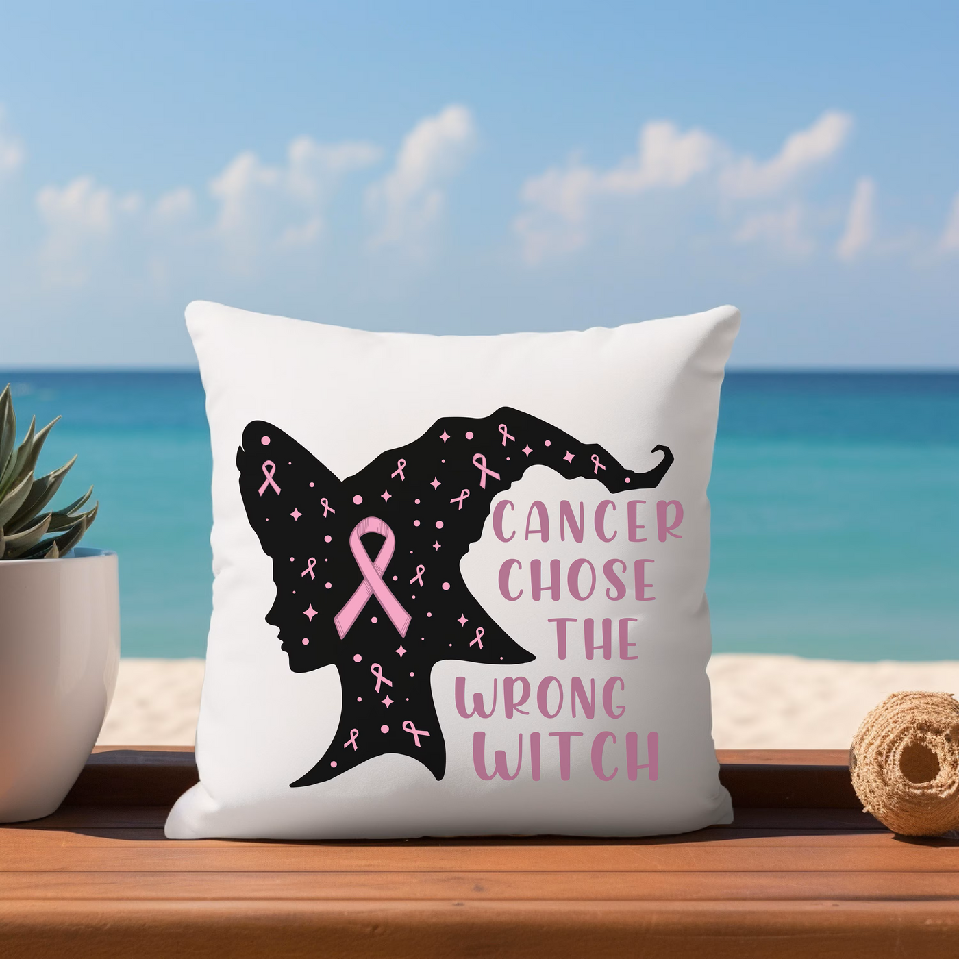 a pillow that has a pink ribbon on it