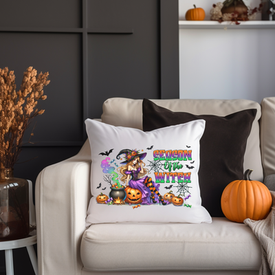 a white couch with a halloween pillow on it