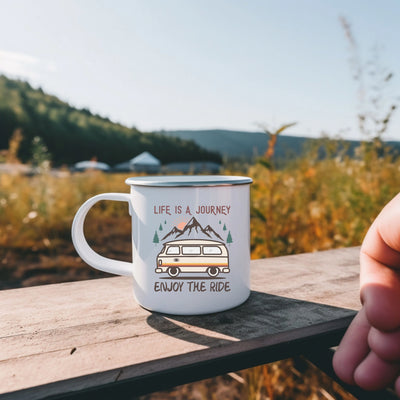 a person holding a coffee mug with a camper on it