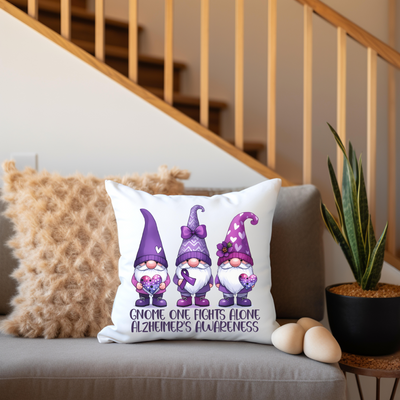 a pillow with three gnomes on it sitting on a couch