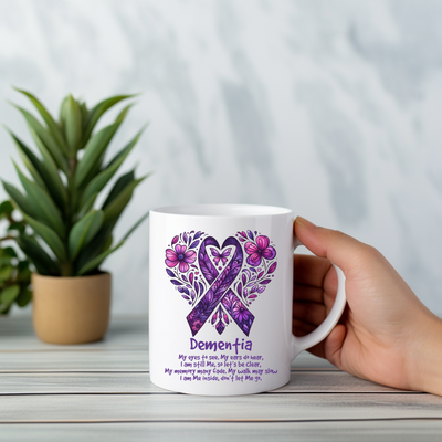 a person holding a coffee mug with a purple ribbon on it