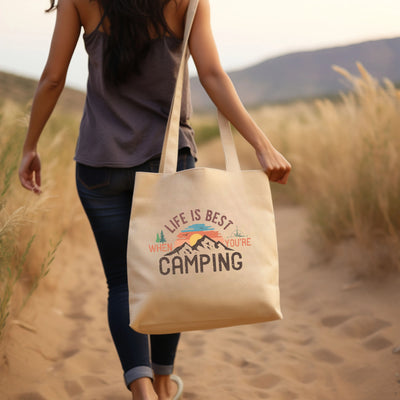 a woman walking down a dirt road carrying a bag