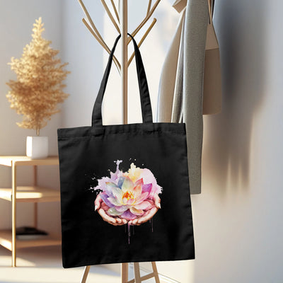 a black tote bag with a flower painted on it