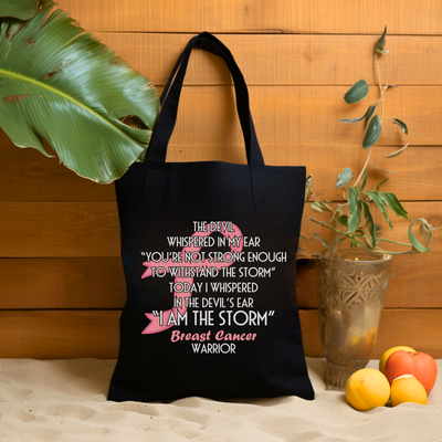 a black tote bag sitting next to a potted plant