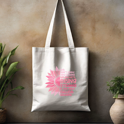 a white tote bag with a pink flower on it