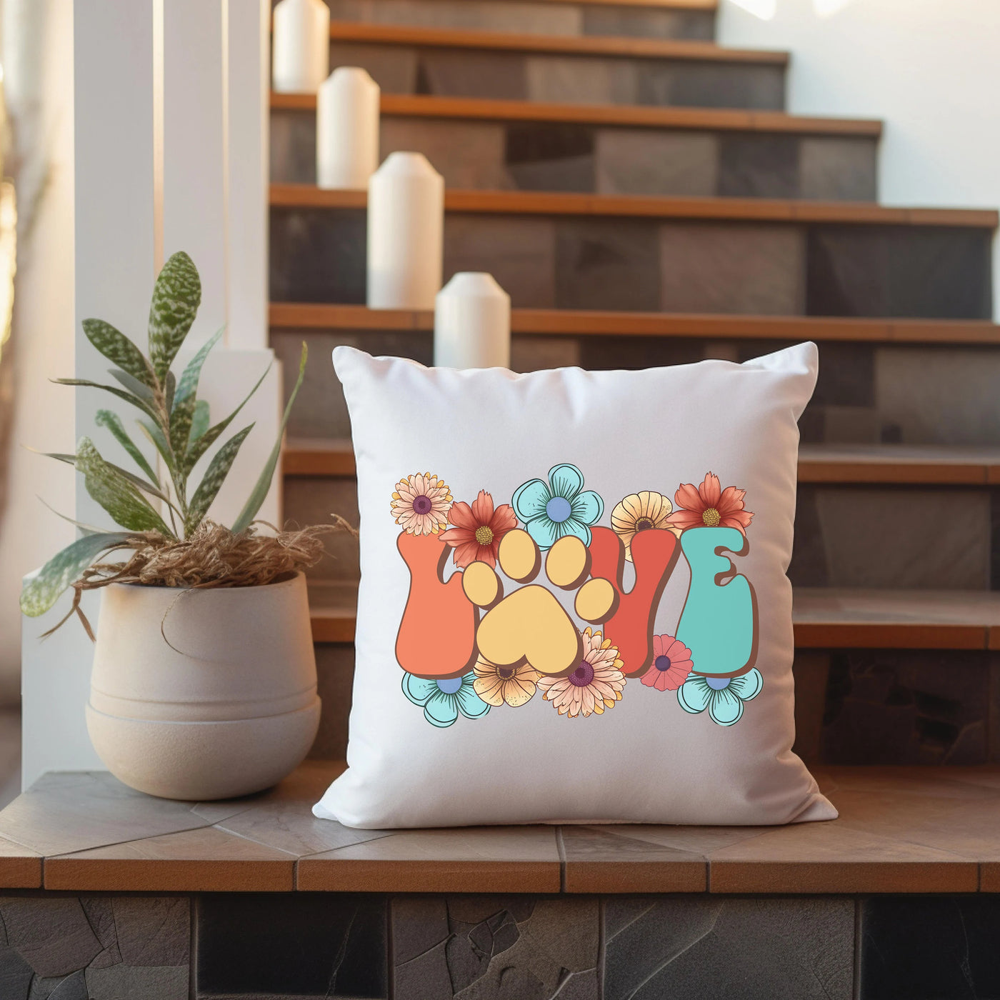 a pillow sitting on top of a table next to a potted plant