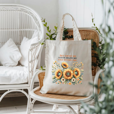 a tote bag sitting on a chair next to a potted plant