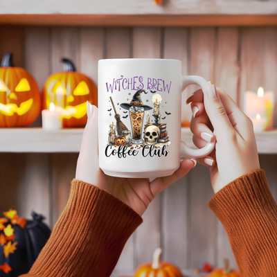 a woman holding a coffee mug with witches brew on it