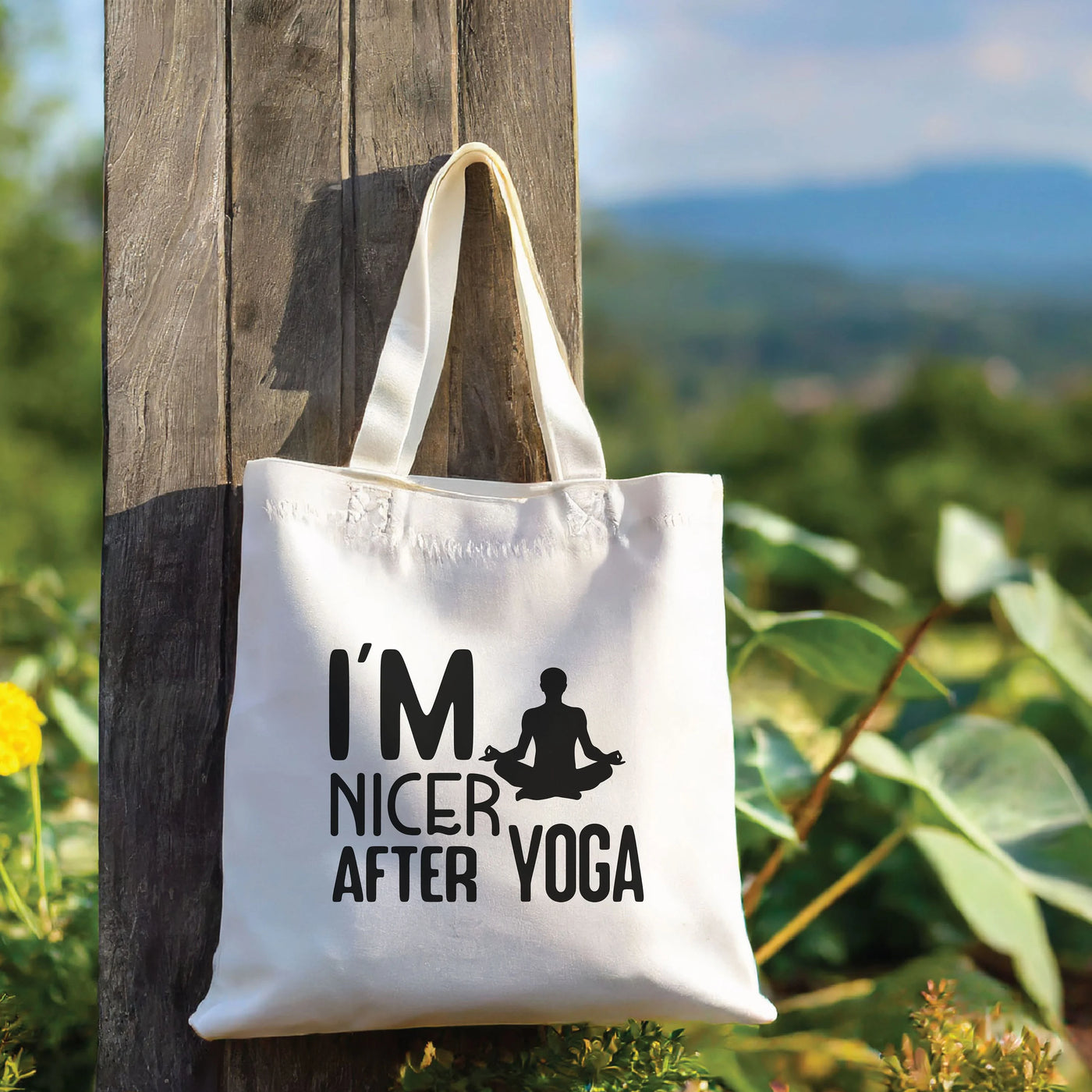 a tote bag hanging from a wooden pole