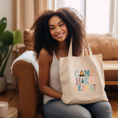 a woman sitting on a couch holding a tote bag