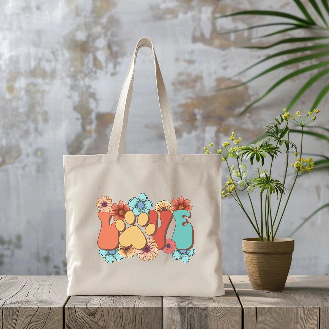 a tote bag sitting next to a potted plant