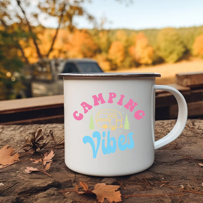 a campin's vibes coffee mug sitting on the ground