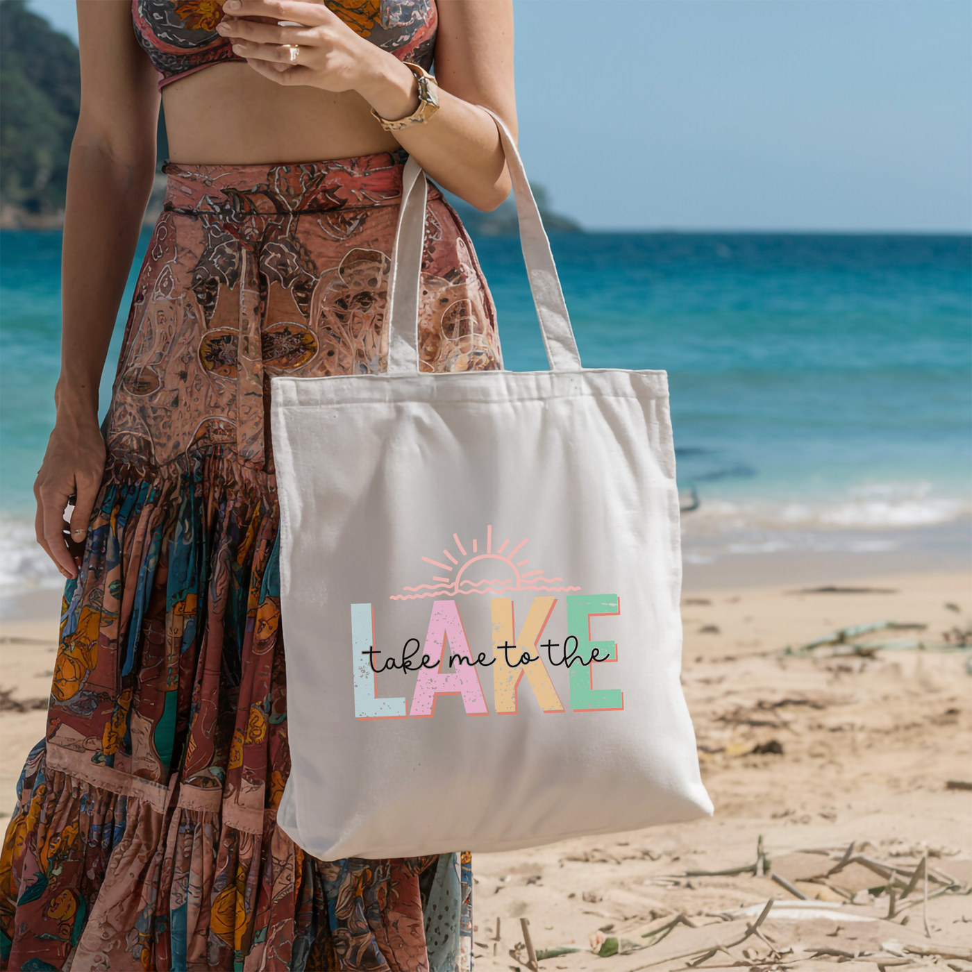 a woman standing on a beach holding a white bag