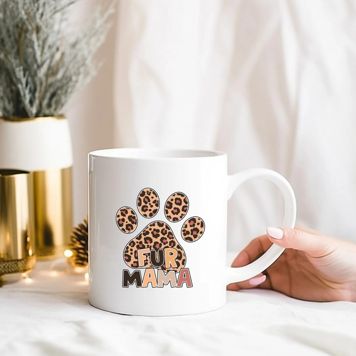 a person holding a coffee mug with a paw print