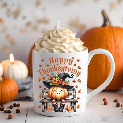 a cup of coffee with whipped cream and pumpkins around it