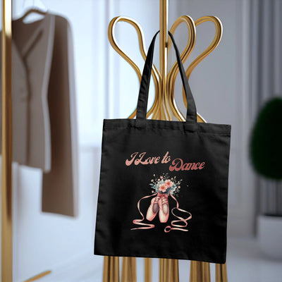 a black shopping bag with a picture of a ballerina on it