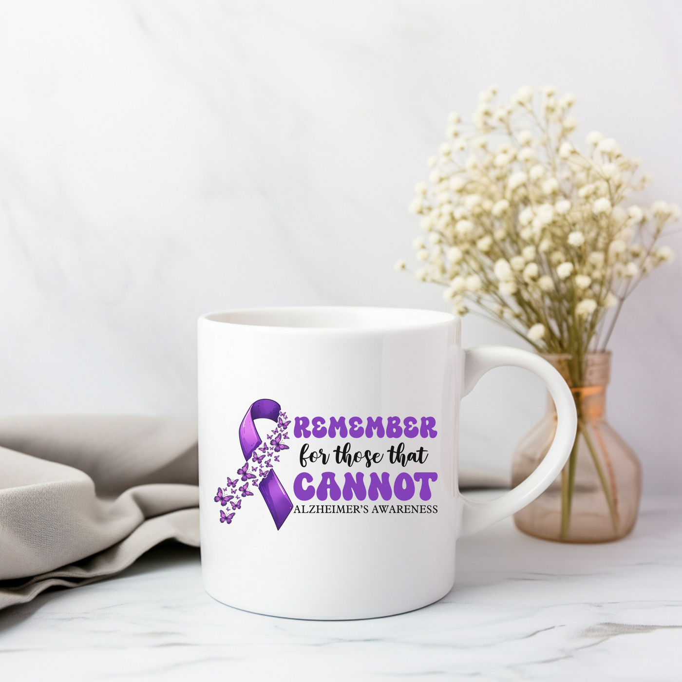 a white coffee mug with a purple ribbon on it