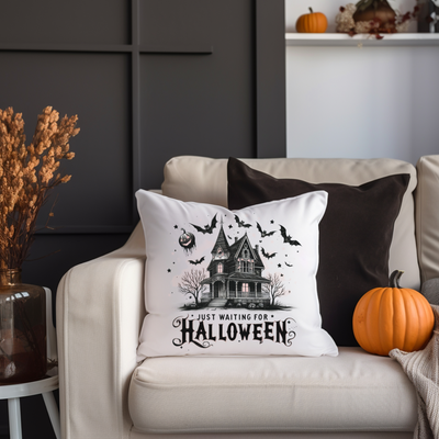 a white couch with a halloween pillow on it