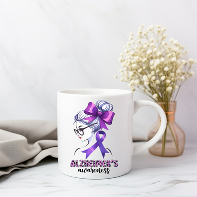 a white coffee mug with a purple ribbon on it