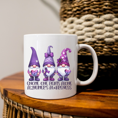 a white coffee mug with three gnomes on it