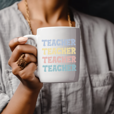 a woman holding a coffee mug with a teacher on it