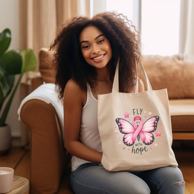 a woman sitting on a couch holding a pink bag