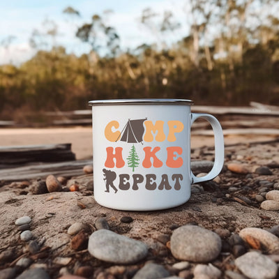 a camp mug sitting on top of a pile of rocks