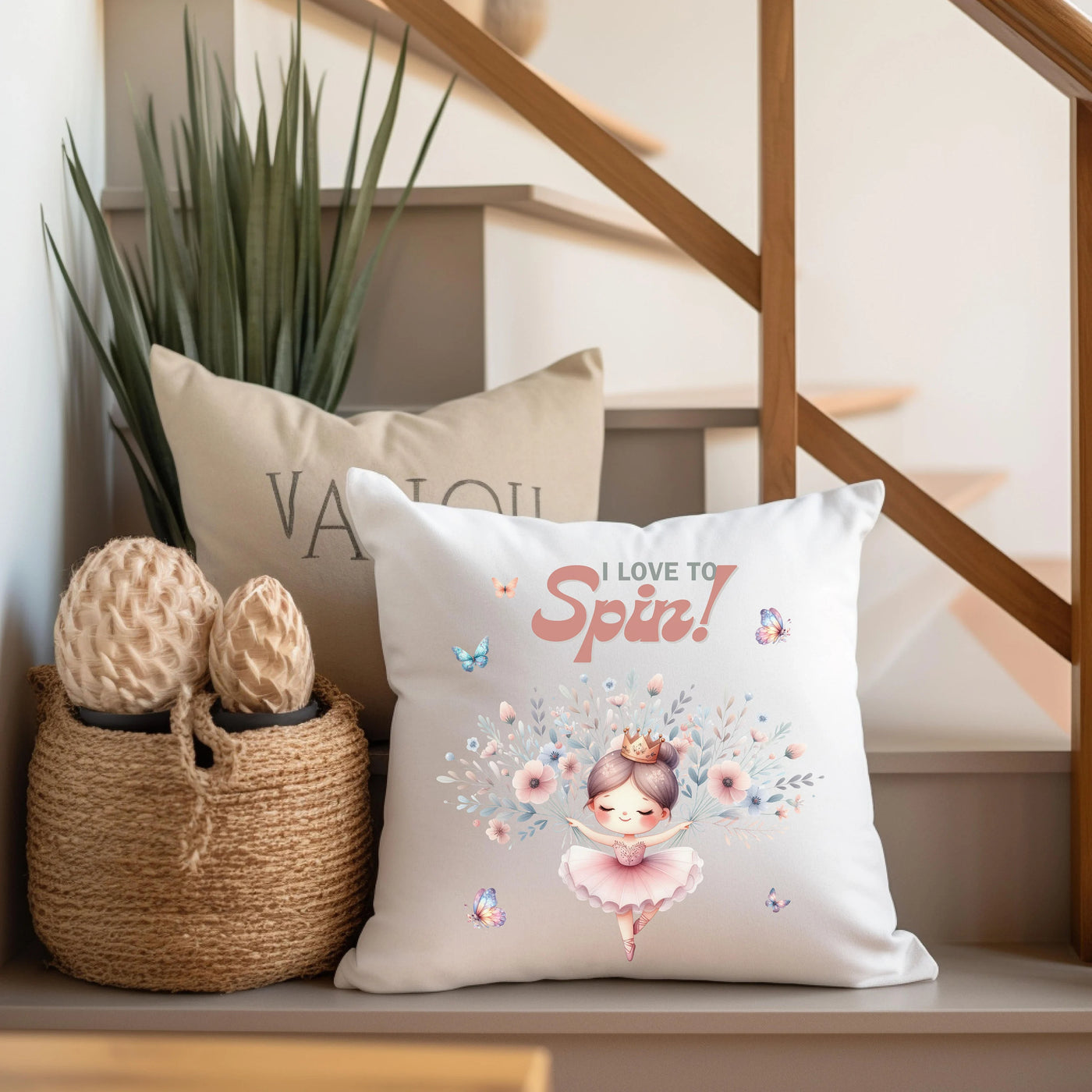 a pillow with a ballerina on it next to a basket