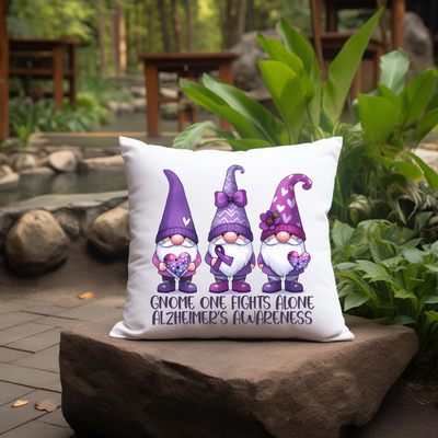 a pillow with three gnomes on it sitting on a rock