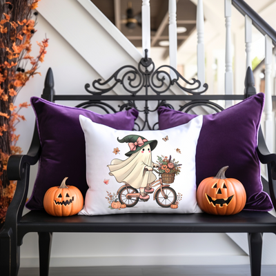 a bench with two pumpkins and a pillow on it