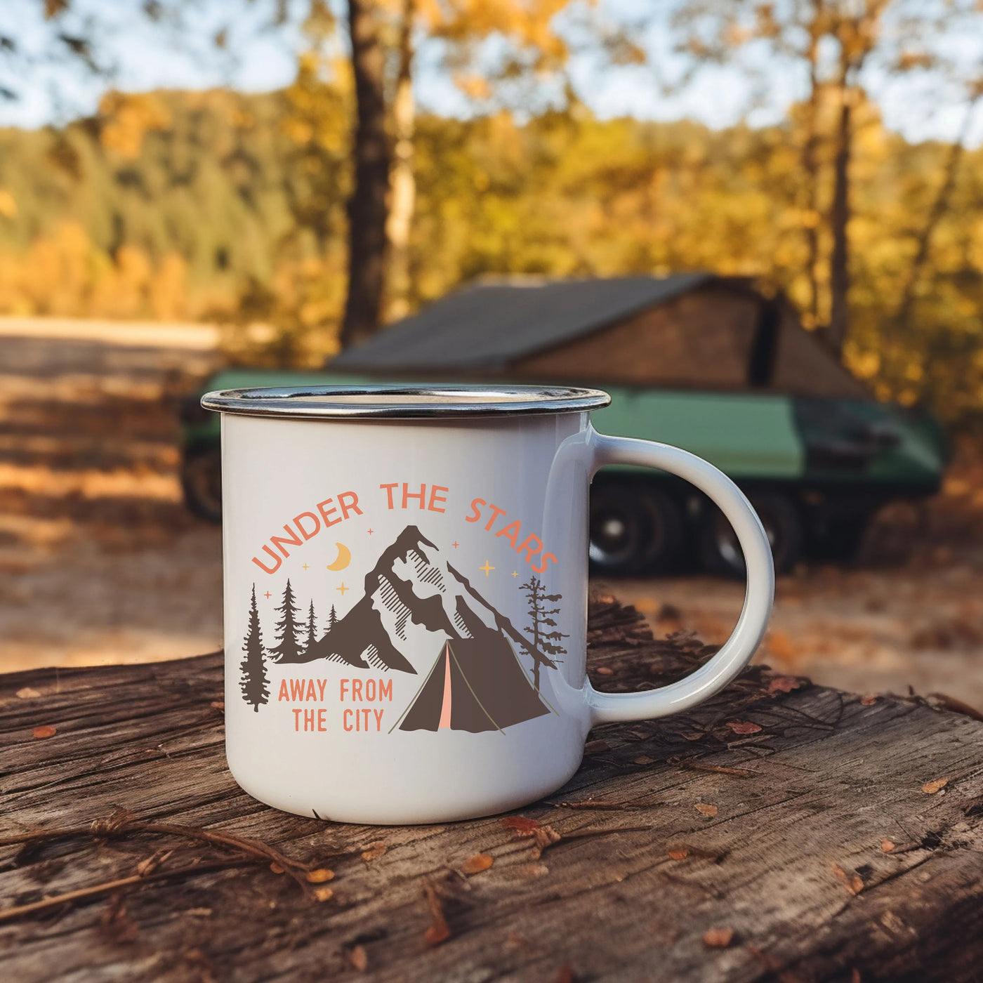 a camper mug sitting on top of a tree stump