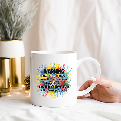 a person holding a coffee mug with a message on it