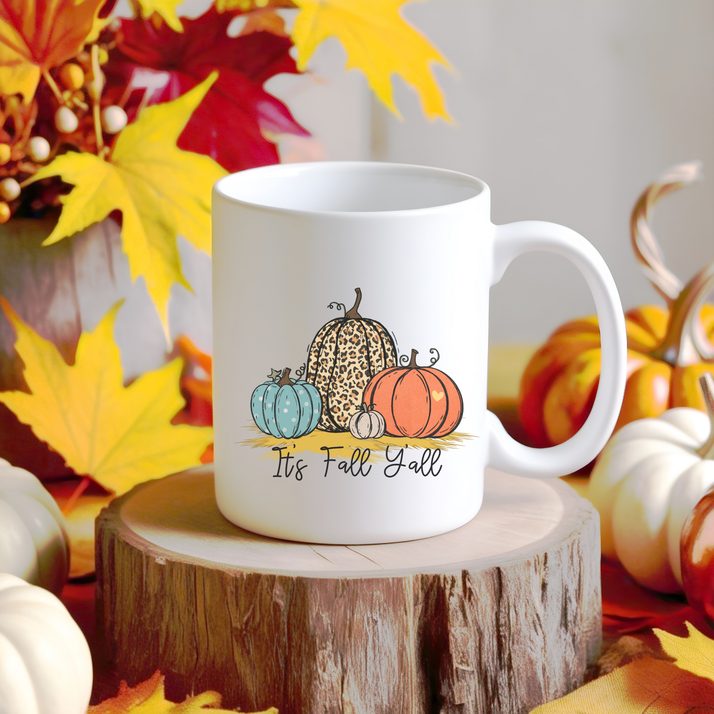 a white coffee mug with pumpkins and gourds on it