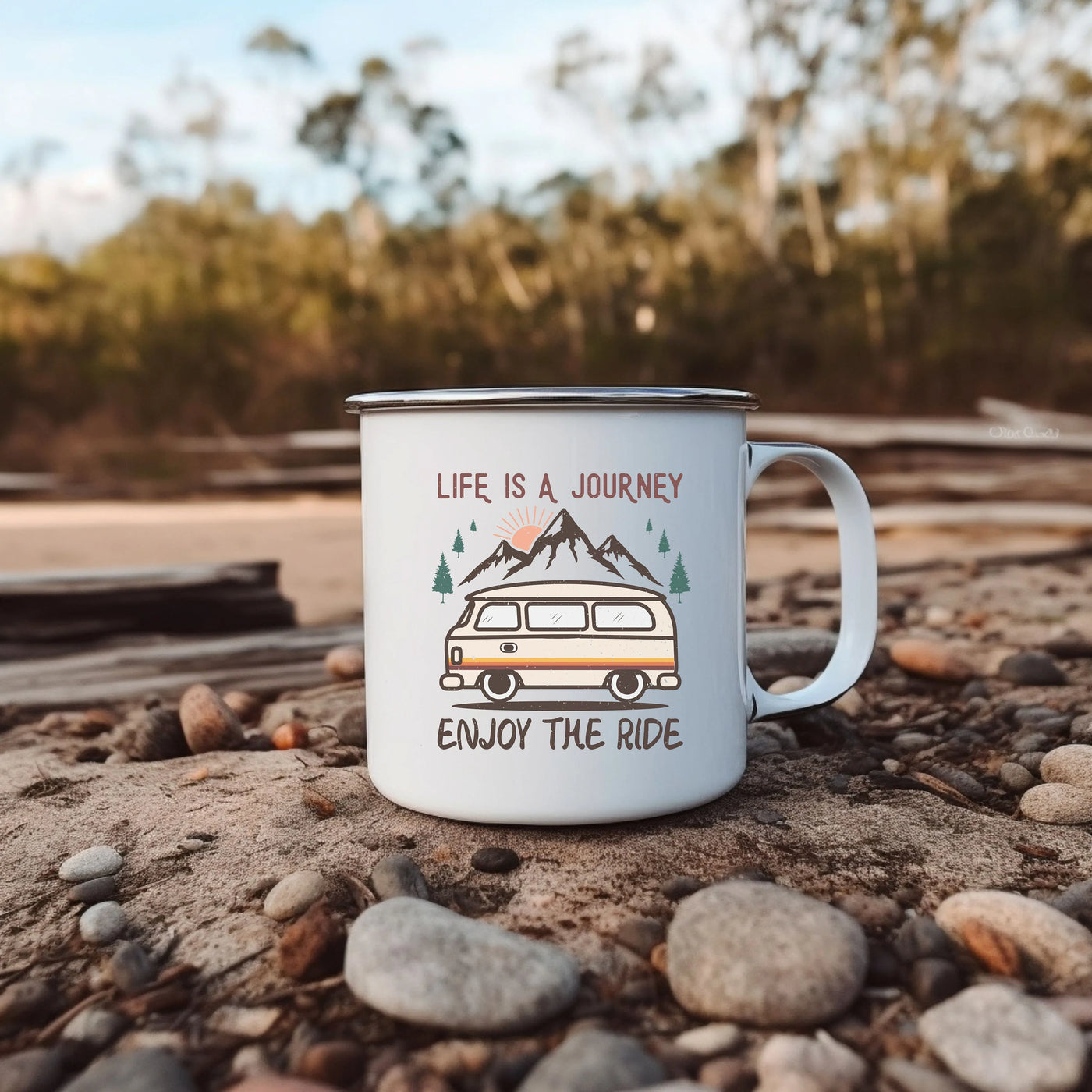 a camper mug sitting on the ground with the words life is a journey enjoy